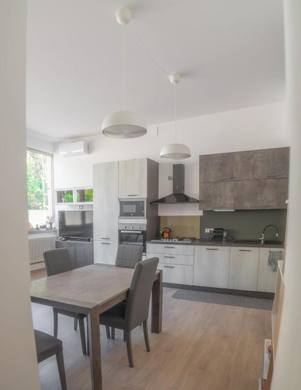 a kitchen with a wooden table and chairs in it at Cernobbio Apartment in Cernobbio