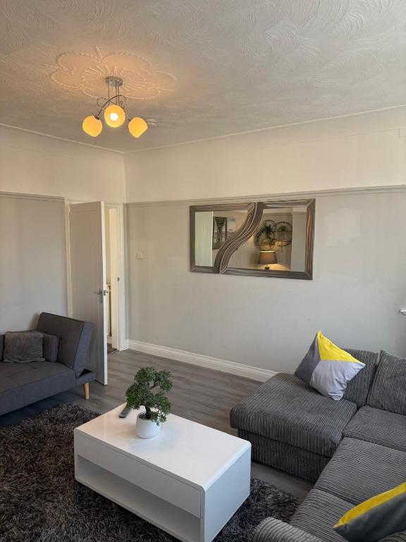 a living room with a couch and a table at Cosy 2 Bed By Pleasure Beach in Blackpool