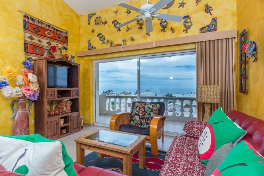 a living room with a view of the ocean at Serene & Warm 3rd Level Condo - Corona del Mar 302 in Puerto Peñasco