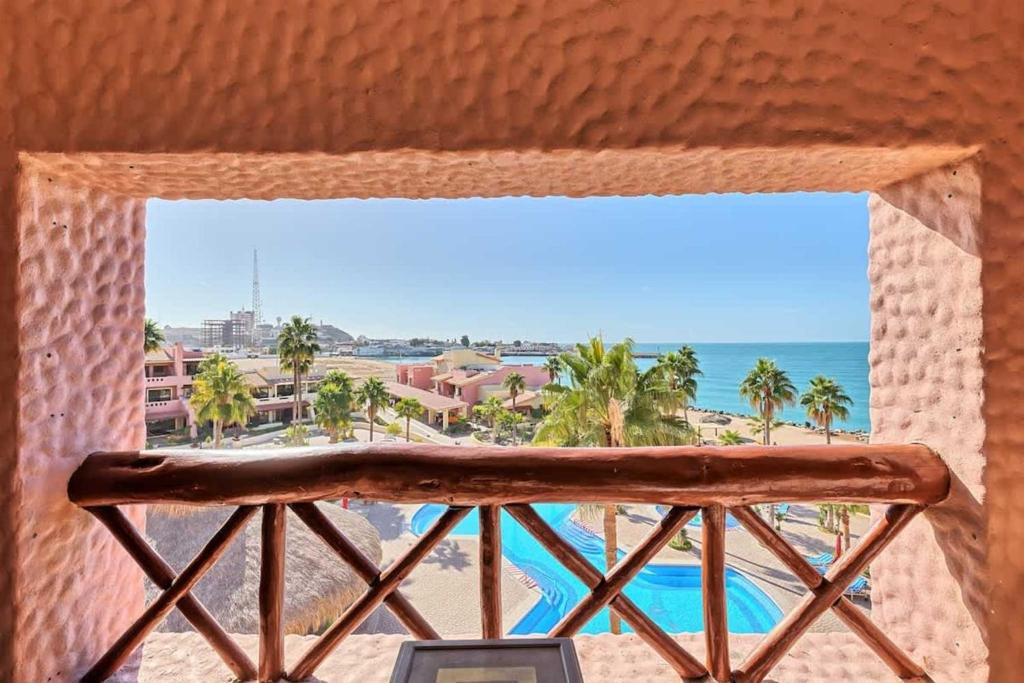 a window with a view of the beach and the ocean at Charming Condo in Great Location Pinacate 412 in Puerto Peñasco