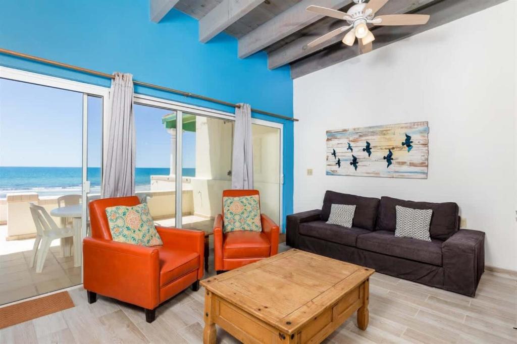 a living room with a couch and chairs and a table at Cozy & Beautiful Beachfront Condo Las Olas II 2 in Puerto Peñasco