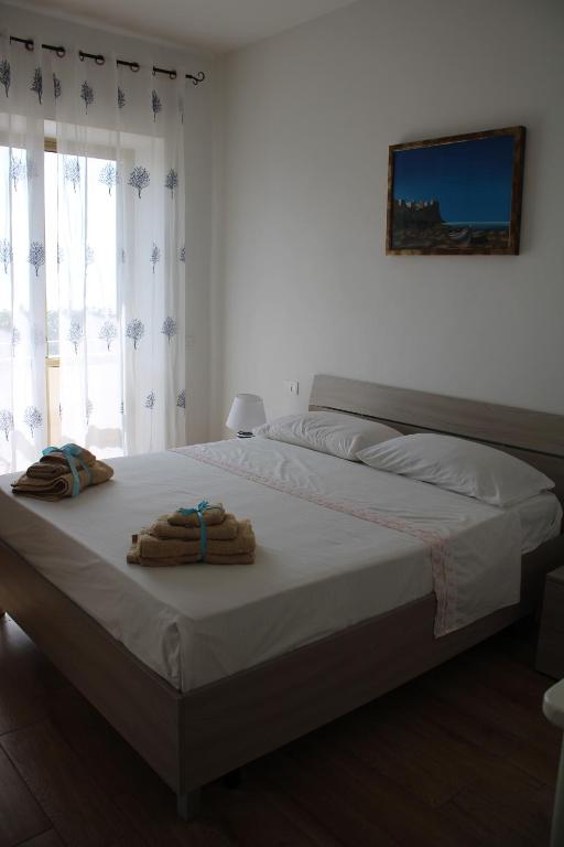 a bedroom with a bed with towels on it at Tropical House in Formia