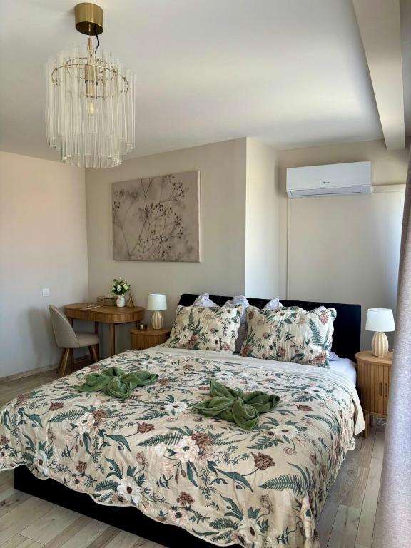 a bedroom with a bed and a chandelier at HelloWine Apartman in Eger