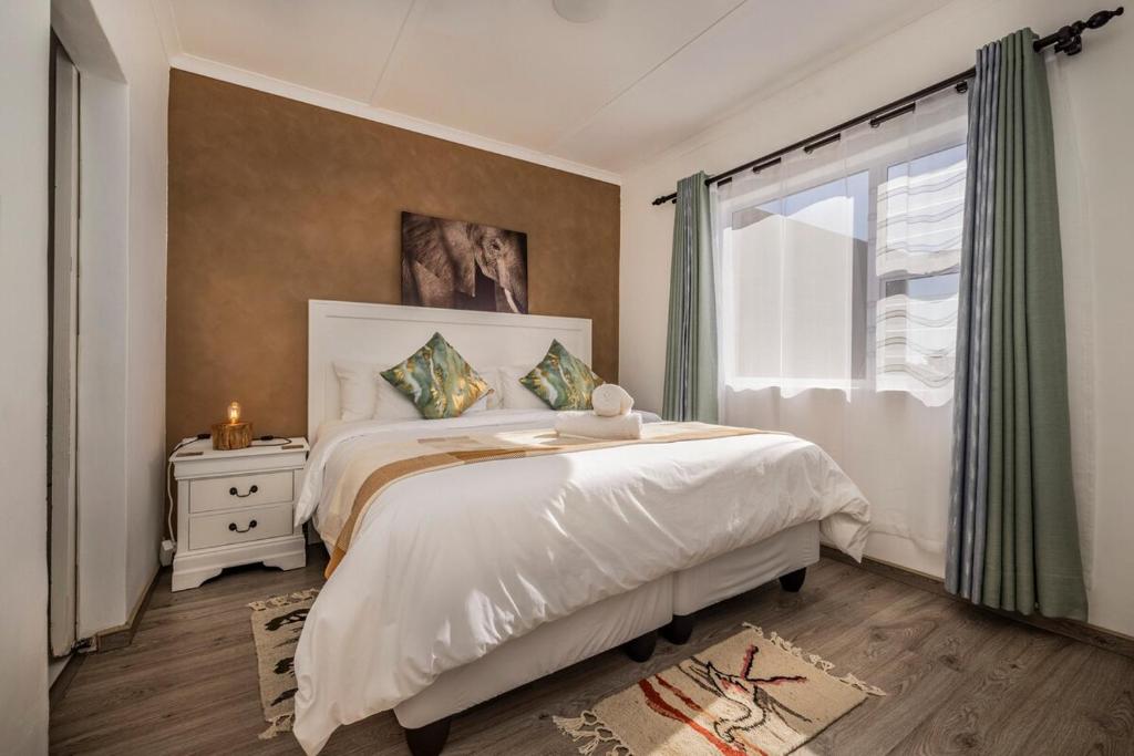 a bedroom with a large bed and a window at Namclassics in Langstrand