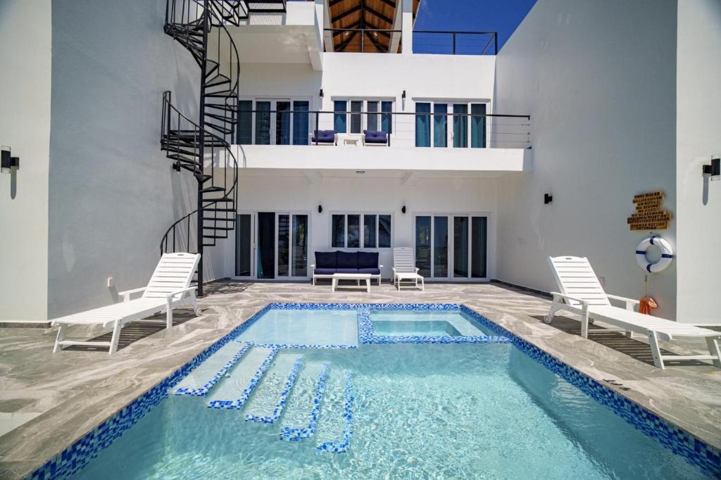 a swimming pool in the middle of a house at Villa Armoniosa Ocean View 2BR w/ Beachfront Pool - Upper Level in Placencia
