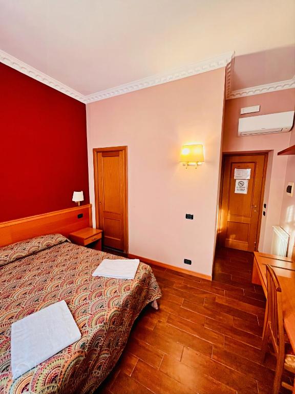a hotel room with a bed and a desk at Beauty Rooms in Rome