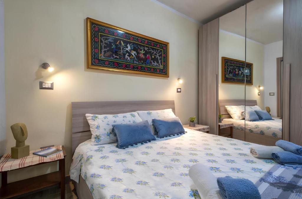 a bedroom with a large bed and a mirror at Relax House & Gym in Villanova Monteleone