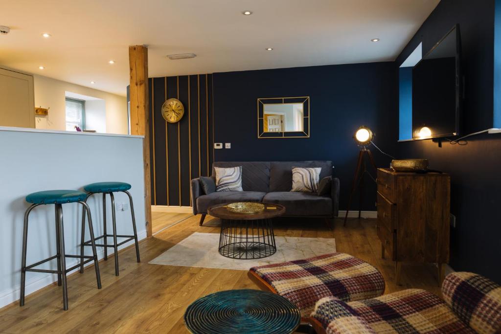 a living room with a couch and a table at Snowdon Studio Apartment in Colwyn Bay