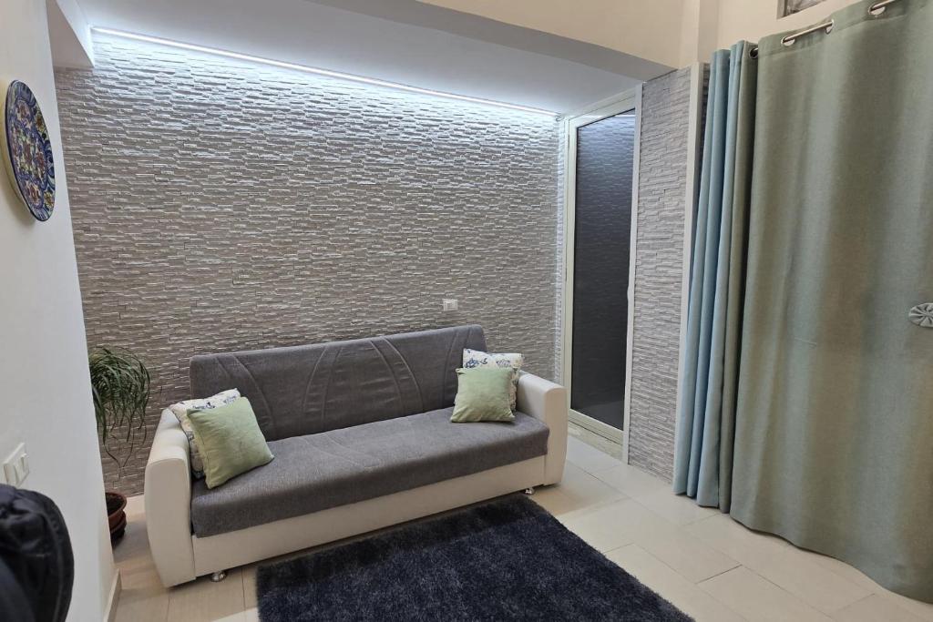 a living room with a couch and a window at CASA CASCIOTTO in Palermo