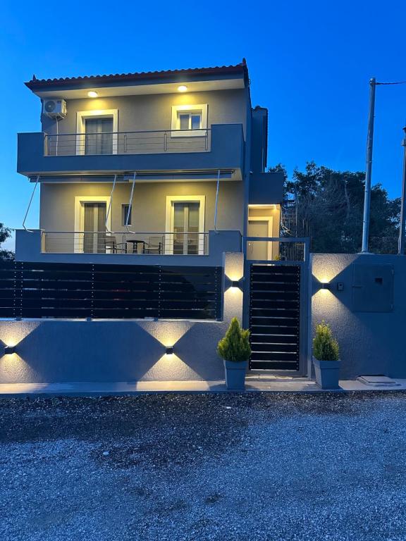 a house with lights on the side of it at Enjoy A&A in Skala Oropou