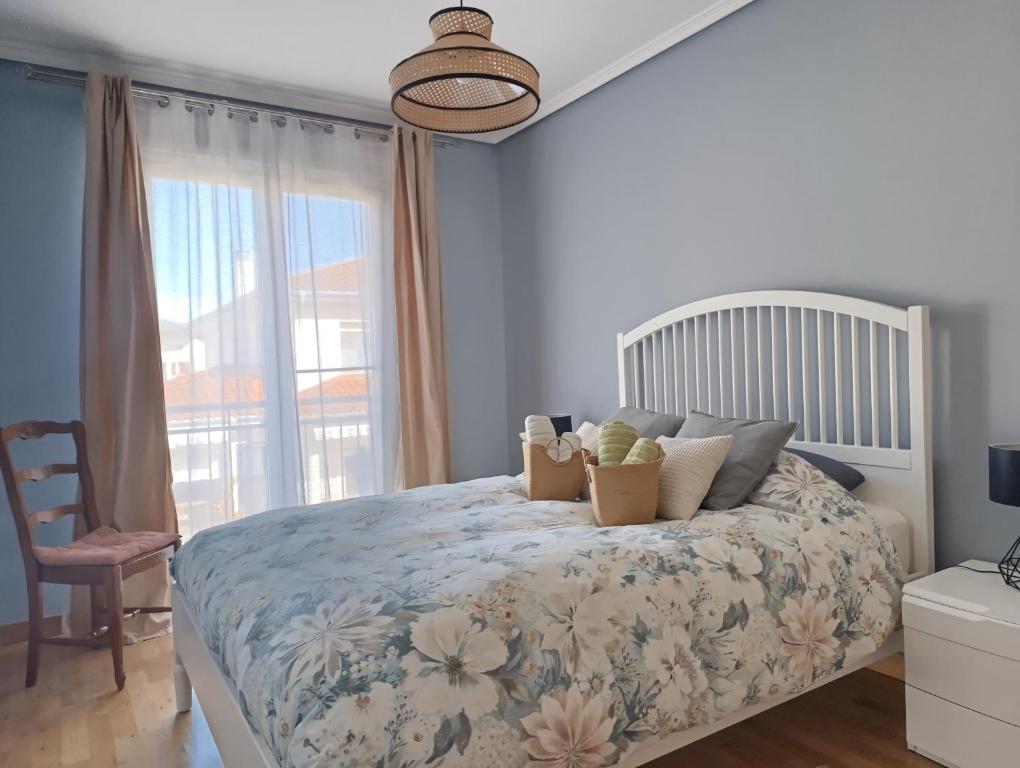 a bedroom with a bed with a large window at Casa María House in Zubiri