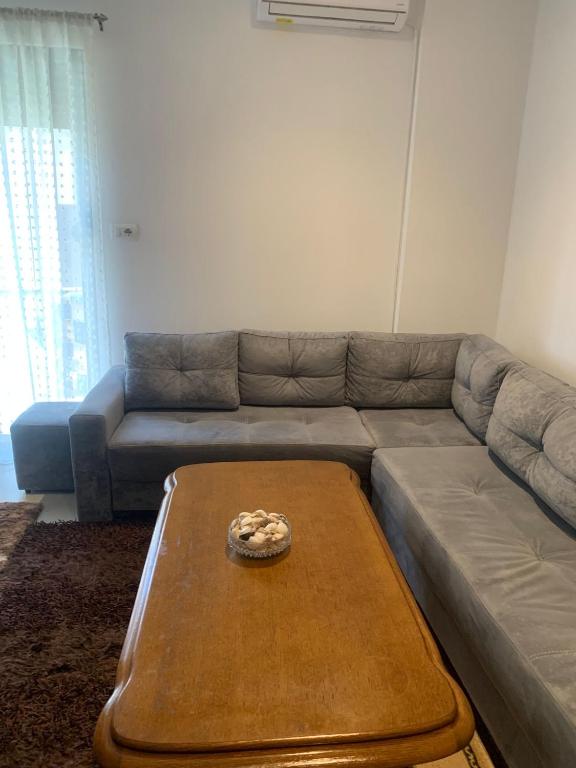a living room with a couch and a coffee table at Golem Central Stay in Golem