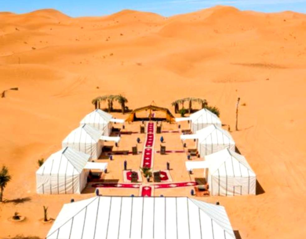 a group of white tents in the desert at Sahara Imperial Luxury Camp in Merzouga