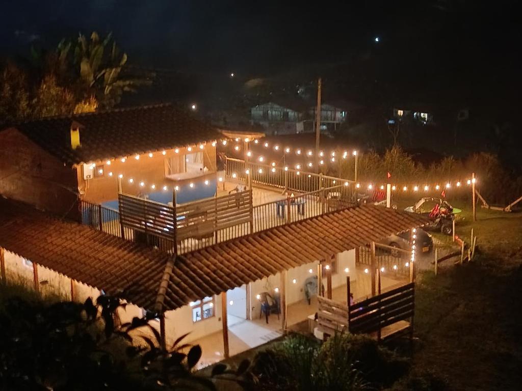 a building with lights on it at night at La Casa de Blue in Guarne
