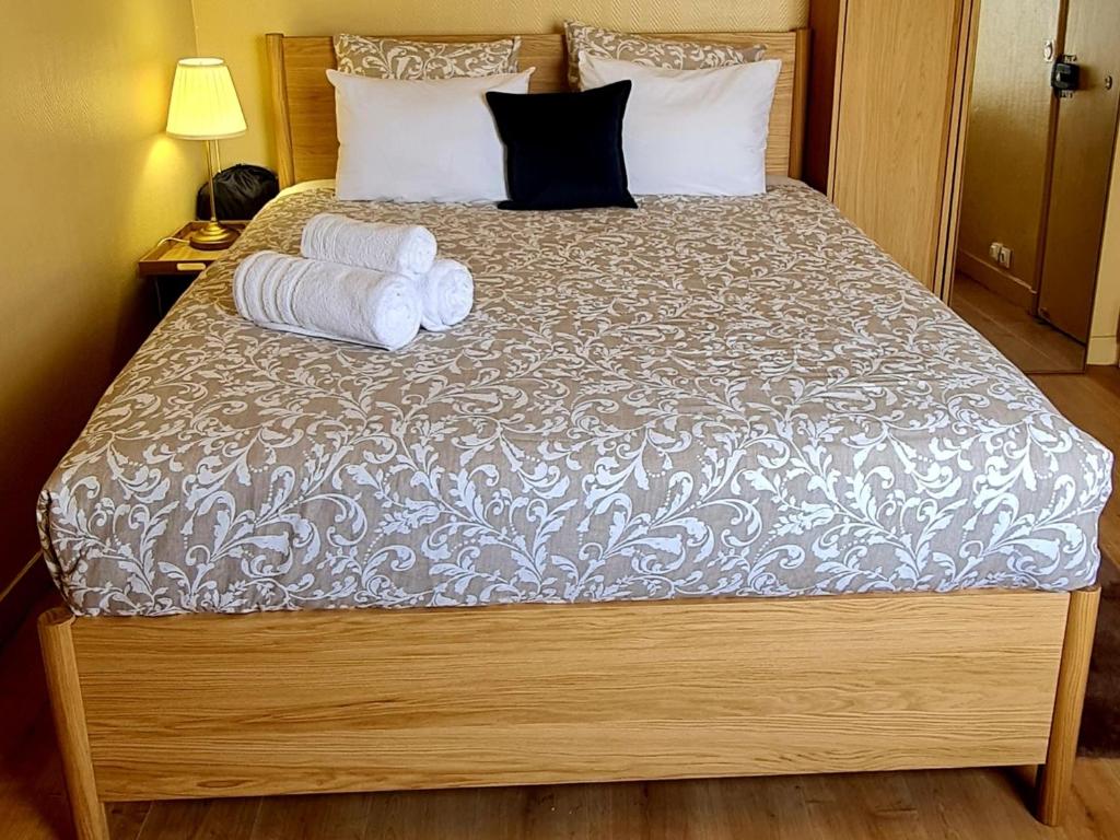 a bedroom with a bed with two towels on it at Charming Getaway Near Paris in Alfortville