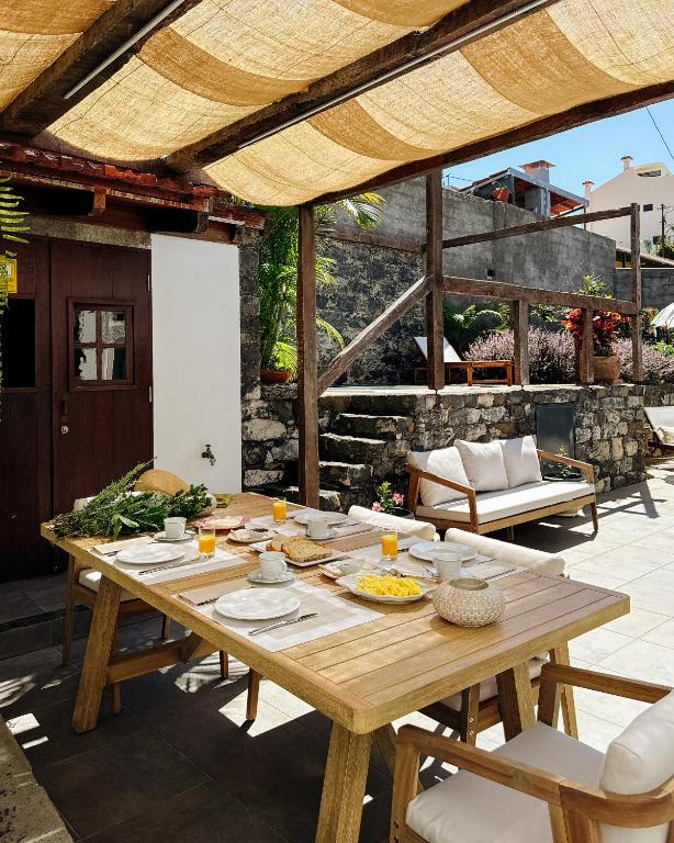 a wooden table with food on a patio at CHC Rochinha Studio in Funchal