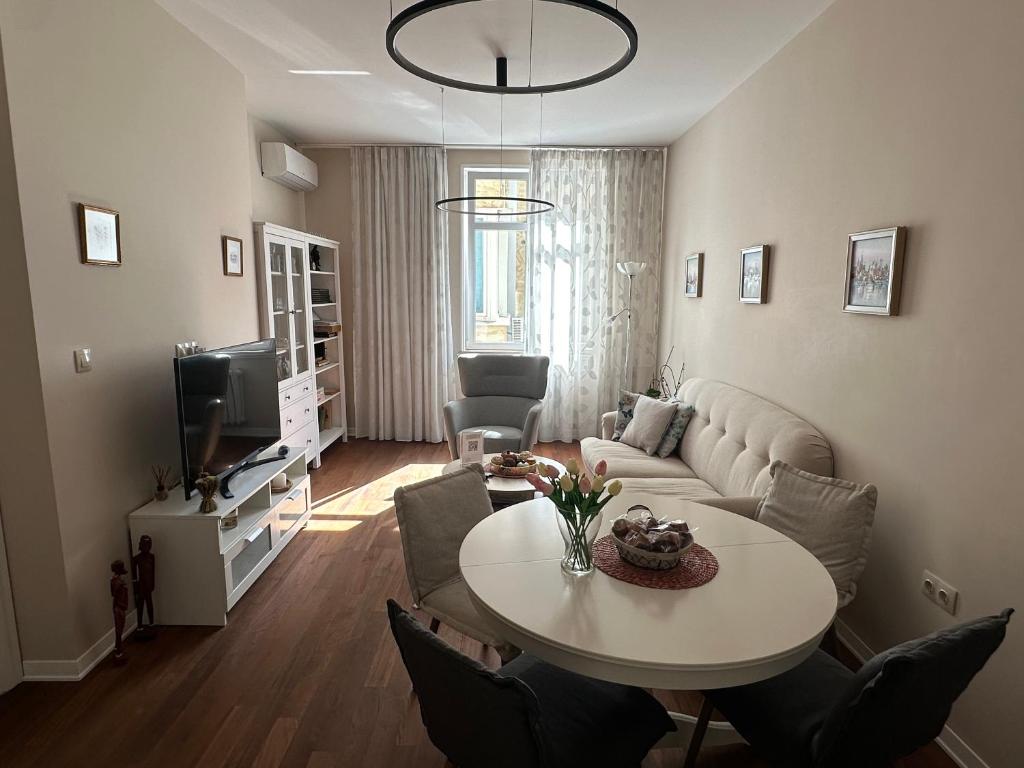 a living room with a table and a couch at Sofo house in Sofia
