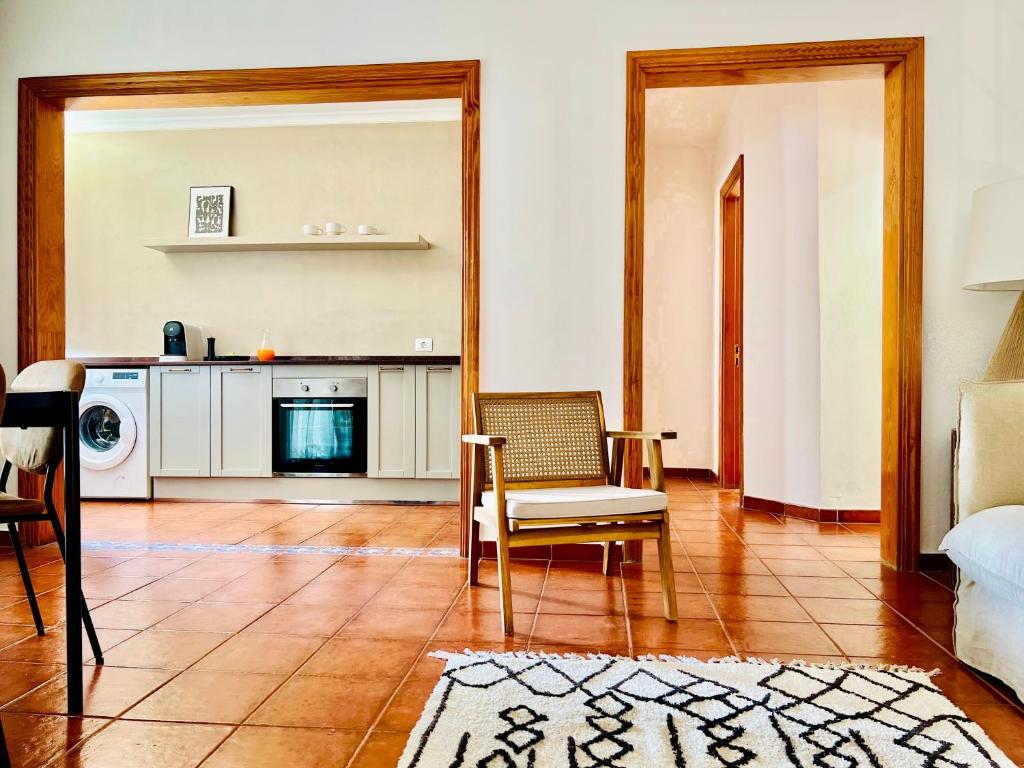 a living room with a couch a chair and a table at Canaryislandshost l Bruma in Famara