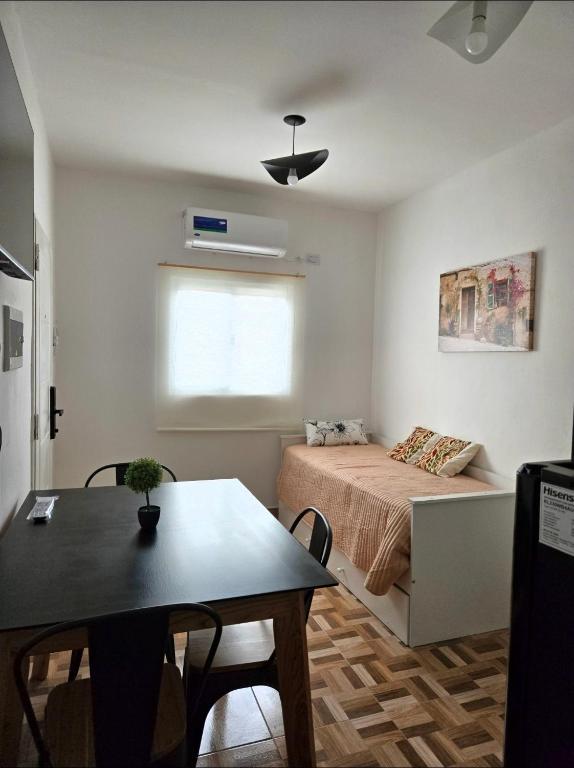 a bedroom with a bed and a table and a window at Cesar - Caesars in La Rioja