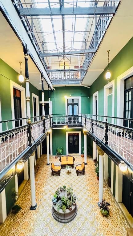 a large building with a lobby with a table at 1825 Hotel in La Paz
