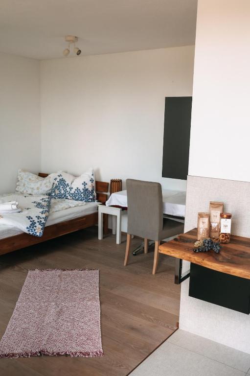 a living room with two beds and a table at Individual room surrounded by nature in Sankt Georgen bei Salzburg