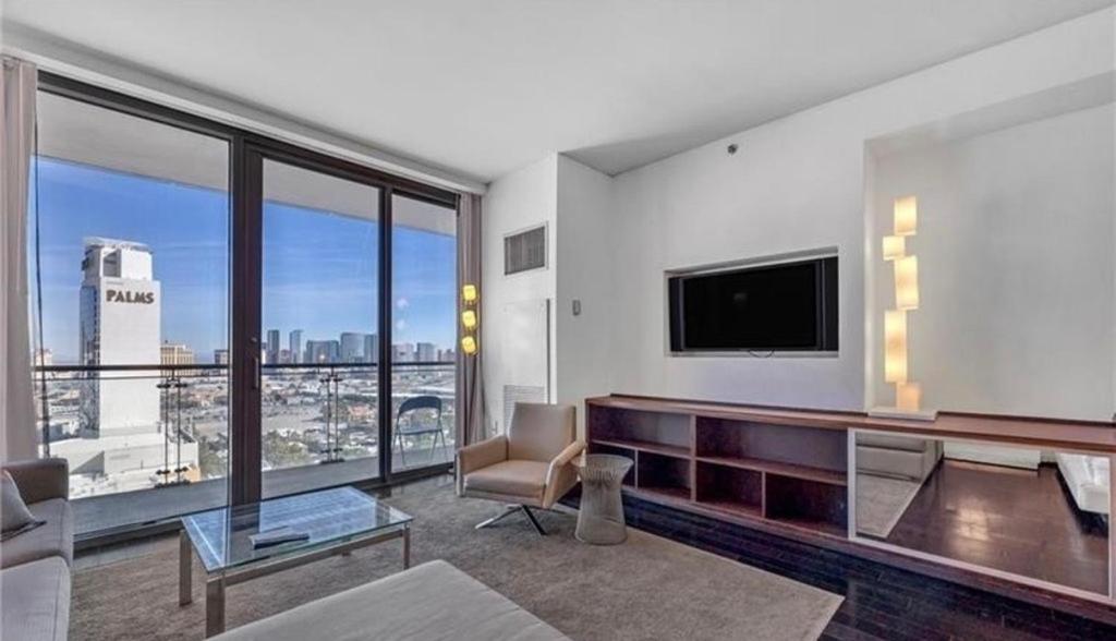 a living room with a flat screen tv and a large window at Justin's at Palms Place in Las Vegas