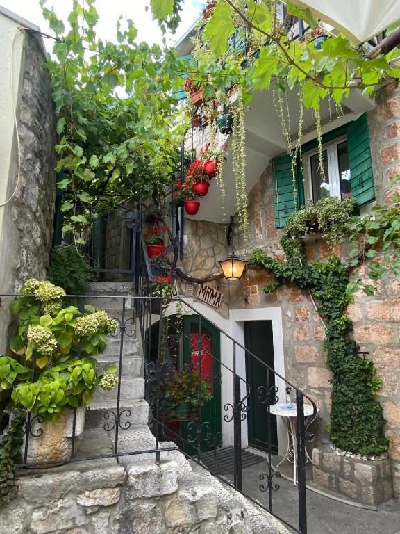 a stone house with stairs and plants on it at Ankora in Omiš