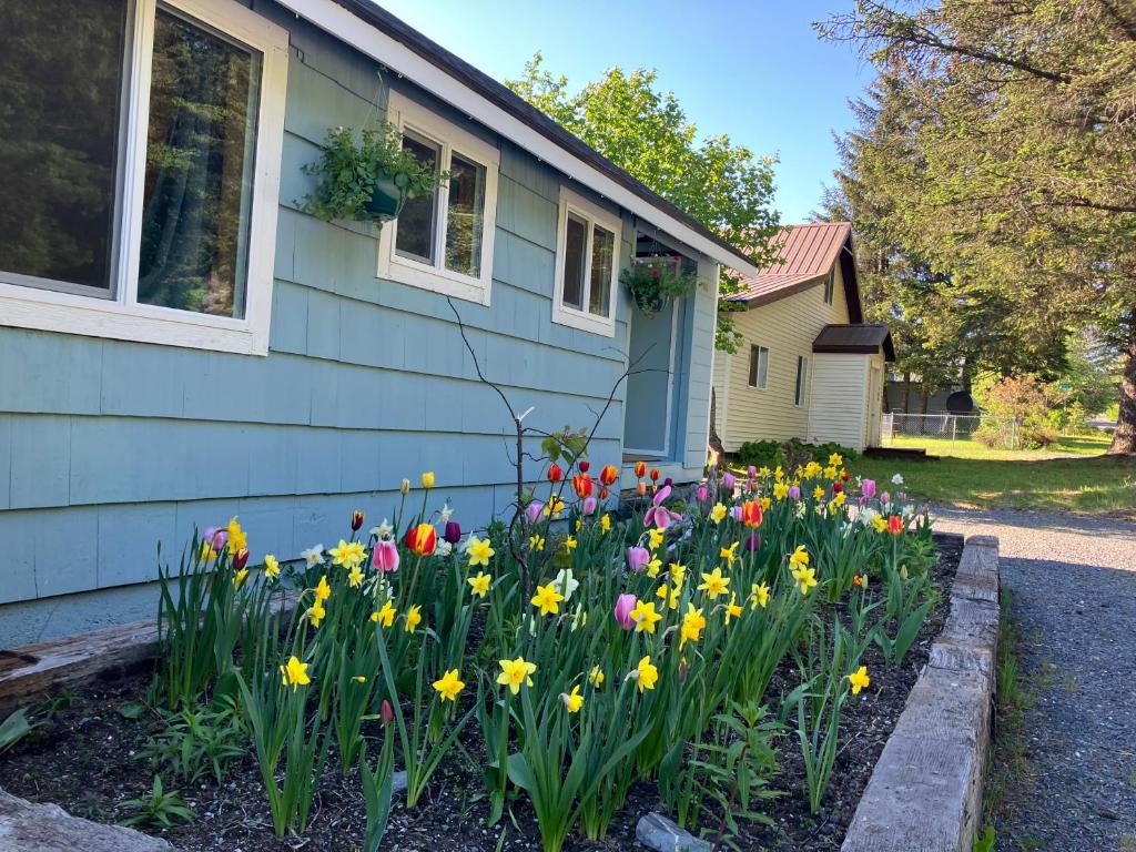 a garden of flowers in front of a house at Two Lakes Guesthouse in Seward