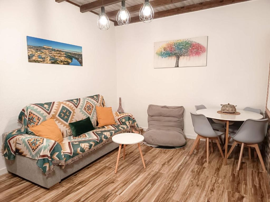 a living room with a couch and a table at La Casita de Ale Casa Rural cerca Puy du Fou in Polán