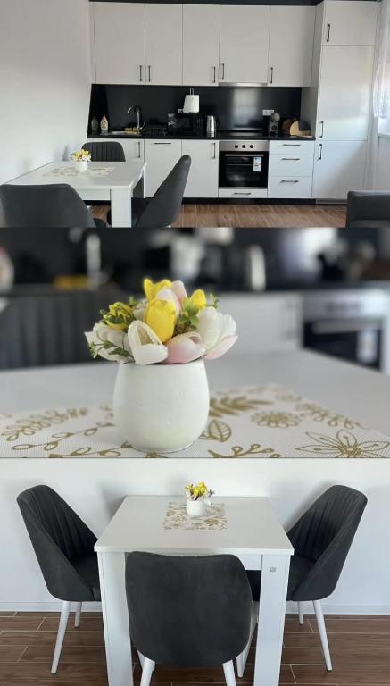 a kitchen with a white table and a vase of flowers at ESEM stan na dan in Modriča