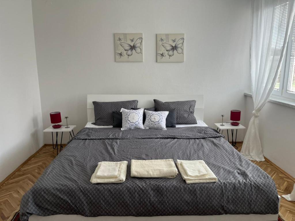 a bedroom with a bed with two towels on it at Relax Visoko Apartman in Visoko