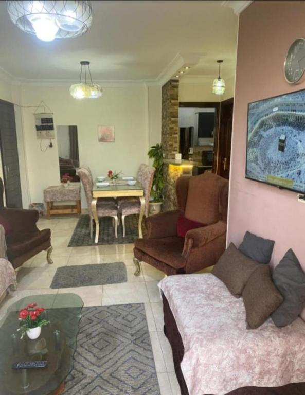 a living room with two couches and a table at Rest and relaxation in Madinaty