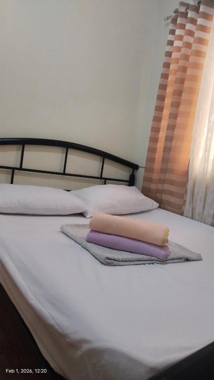 a bed with two towels and pillows on it at Hanna's Condo at Sanremo Oasis in Cebu City