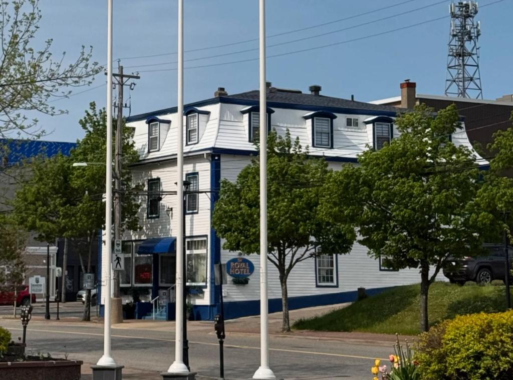 a white house with blue trim on a street at Royal Hotel Sydney in Sydney