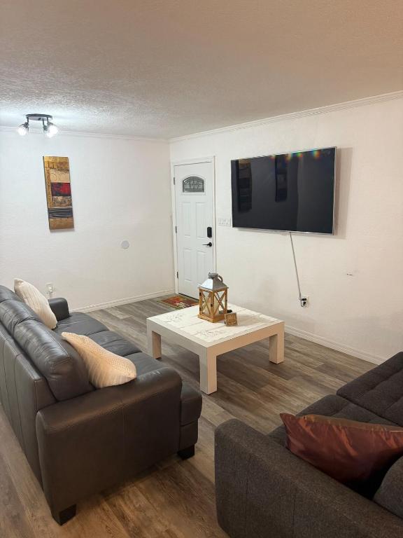 a living room with a couch and a table at Welcome to Highland Shore in Ellenton