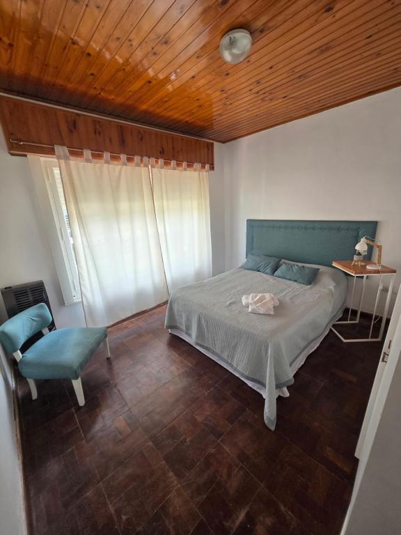 a bedroom with a bed and a table and a chair at Casa Blanca Verónica in Veronica