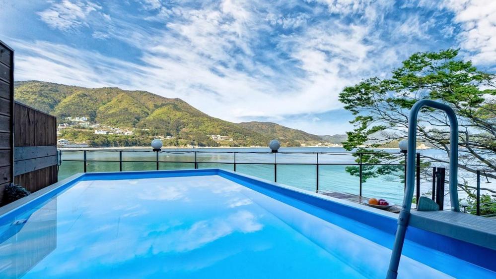 a swimming pool with a view of the water at Geoje Theview Kids Poolvilla in Geoje