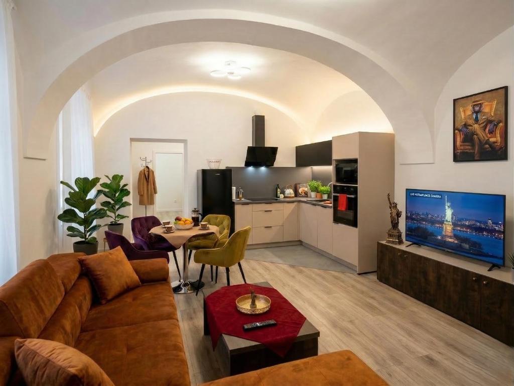 a living room with a couch and a table at Alma Apartment DOWNTOWN in Košice