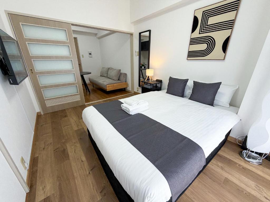 a bedroom with a large bed in a room at OUCHI HOTEL Peace Memorial Park in Hiroshima