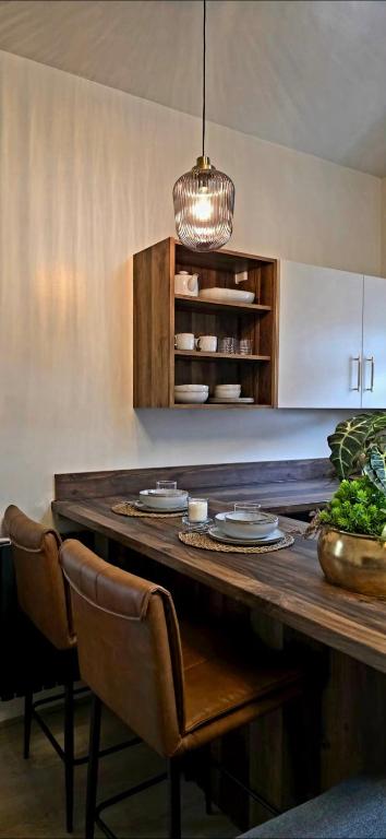 a kitchen with a large wooden table with chairs at Dabbagh Residence in Lees