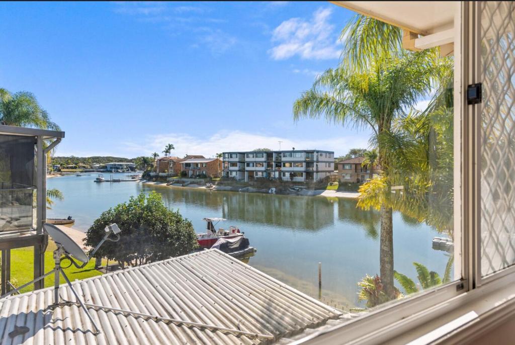 a view of a river from a window at Family Friendly 2 Bed Flat with Balcony in Mooloolaba