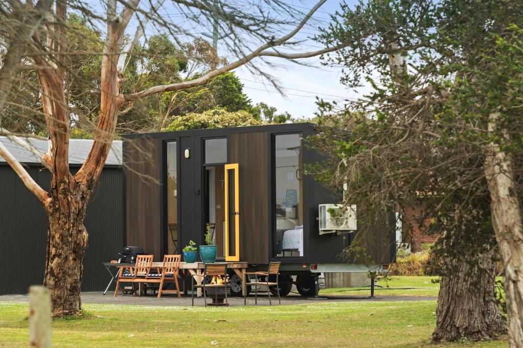 a tiny house on a trailer with a table and chairs at Oceans Edge Retreat by Tiny Away in Portland
