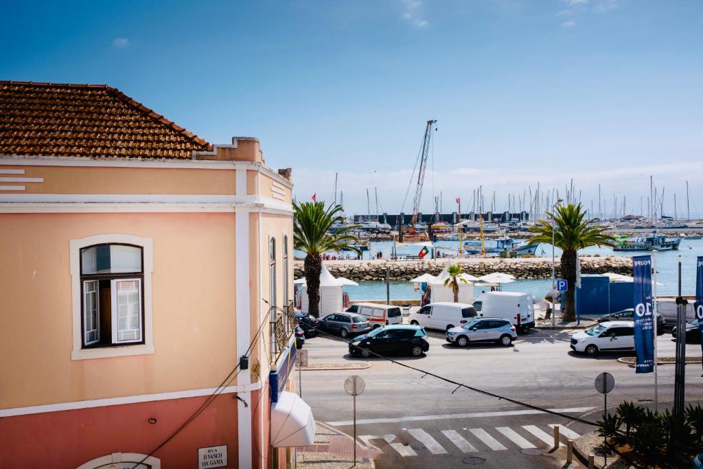 a view of a marina with cars parked in a parking lot at Guest House Vasco da Gama in Lagos