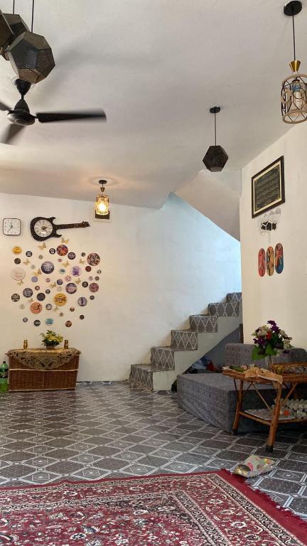 a living room with a couch and a ceiling at Scenic Mountain Hut Naranag in Kangan