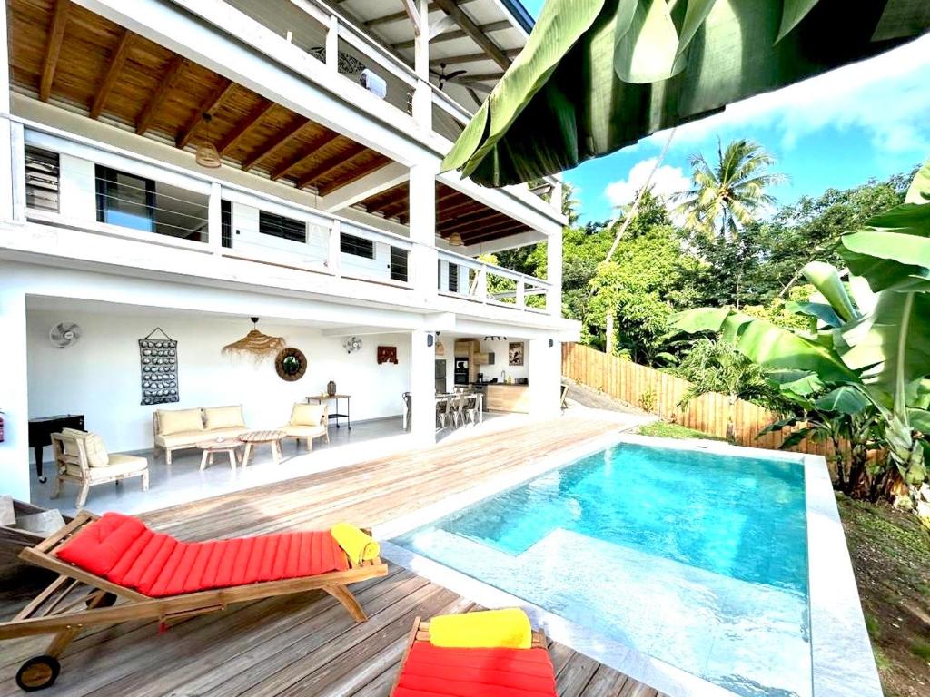 a patio with a swimming pool and a house at Villa Tiare in Bora Bora
