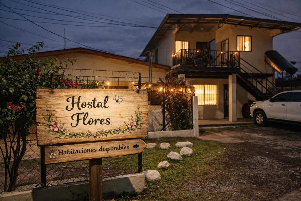 a sign in front of a house with a house at Hostal Flores in David