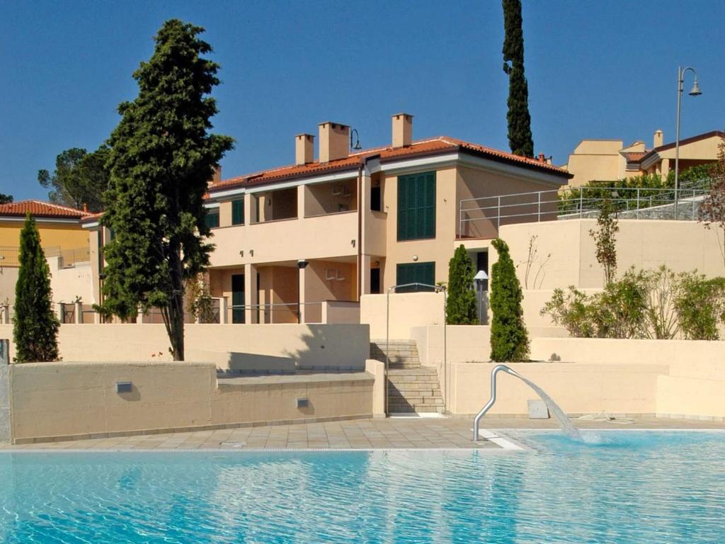 a house with a swimming pool in front of a house at Apartment in Cogoleto with pool in Cogoleto