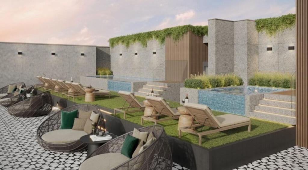 a patio with a bunch of chairs and a pool at Warm & Exclusive 2 BR in San Antonio