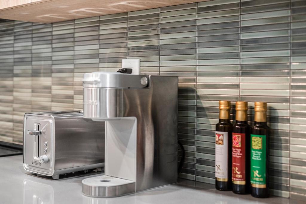 a coffee maker and bottles of wine on a counter at Cozy Spacious 2BR Suite with Parking & Wi-Fi in Hamilton