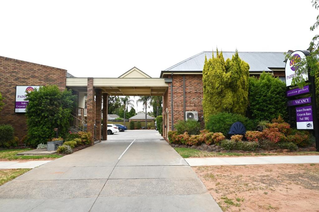 a driveway leading into a brick building with a garage at Paddlewheel Motel in Echuca